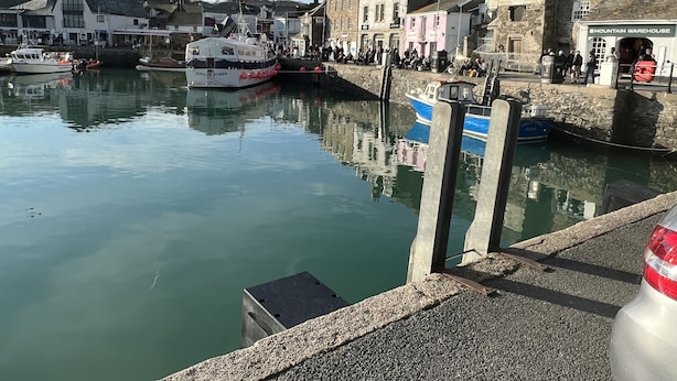A harbor with boats docked, a stone building labeled 'Mountain Warehouse', and a crowd of people on the pier. - Sleeps8- Ecofriendly- Kingbeds- Familyfriendly (Wadebridge)