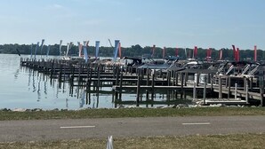 A marina with docked boats and a clear sky.
