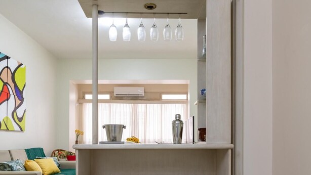 A compact kitchen area with two stools, a countertop, and a mirror above. - 2 Minutes From Copacabana Beach A303 (Rio de Janeiro)