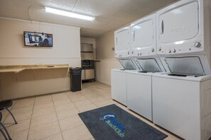 Convenient laundry facilities with washing machines, dryers, and a sink.