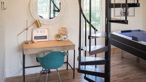 A room with a desk, chair, and a spiral staircase. - "The Primm Loft" Private, Spacious, Clean & New (Murfreesboro)