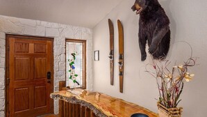 A wooden reception desk, a mounted bear head, and a stained glass window. - Lakefront! Hot Tub-Fire Pit, game room, paddle boards & canoe! (Kimberling City)
