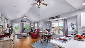 A spacious living room with a dining area, a kitchen, and a balcony. - Resort Living, 2 miles to Silver Dollar City, Ozark views, resort amenities (Reeds Spring)