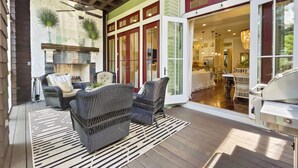 An outdoor patio with wicker furniture, a patterned rug, and a grill. - "116 Surfer Ln" | Resort Style Community Pool | Walk to Rosemary Beach (Seacrest Beach)