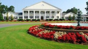 A large white building with a symmetrical facade, columns, and a central entrance. - Calm Retreat or Golf Getaway! Close to Local  Attractions. (Calabash)