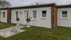 A modern two-story house with a white exterior, brick accents, and a small front garden. - Stunning  villa for 4 people with TV and terrace (Norden)