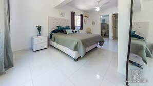 Un dormitorio con cama, mesita de noche y espejo.
