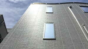 A building with a textured facade and multiple rectangular windows. - Asakusa HomeSuites Tokyo (Tokyo)