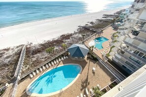A resort with a large pool, a smaller pool, and a beach view. - Beachfront Condo with Pool and Beach Access! (Orange Beach)