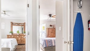 Une chambre à coucher avec un lit, une commode et un miroir.