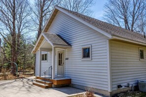 A single-story house with a front porch, a small garage, and a number '8808' on the door. - Blue Skies and Cherry Pies, in Fish Creek! (Fish Creek)