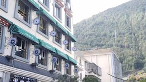 A traditional building with multiple windows and a signboard. - Yunqi Hotel (Jiulong)
