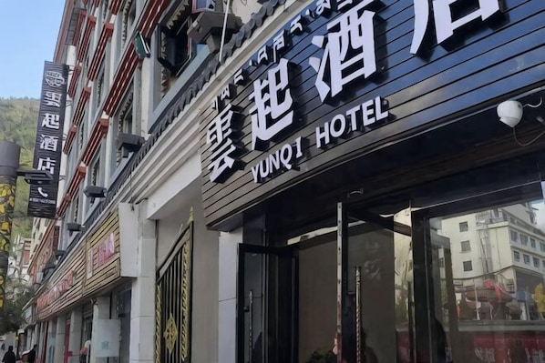 Un letrero de hotel con caracteres chinos y el nombre 'YUNQI HOTEL' en inglés.