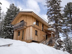 A wooden chalet with multiple balconies, surrounded by snow-covered trees. - # 6 mit IR-Sauna und Sprudelwanne Innen by Interhome (Turracher Höhe)