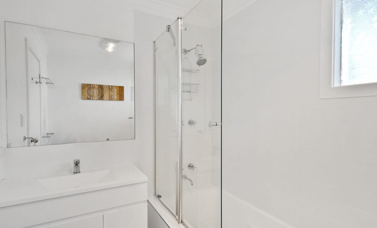Combined shower/bathtub, towels, toilet paper
