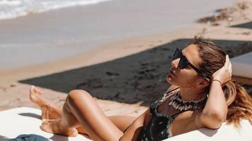 On the beach, sun-loungers, beach umbrellas, beach towels