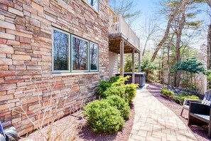 Enjoy a serene outdoor space with a paved walkway, seating area, and lush surroundings.