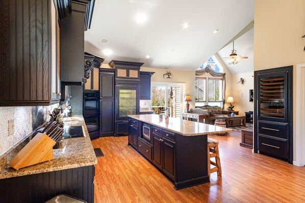 Enjoy cooking in this well-lit kitchen with a large island and granite countertop.