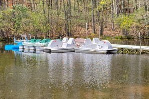 Enjoy leisurely paddling on the serene lake surrounded by lush greenery.