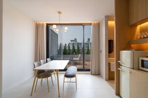 Luxury Suite, City View | Living area | Flat-screen TV