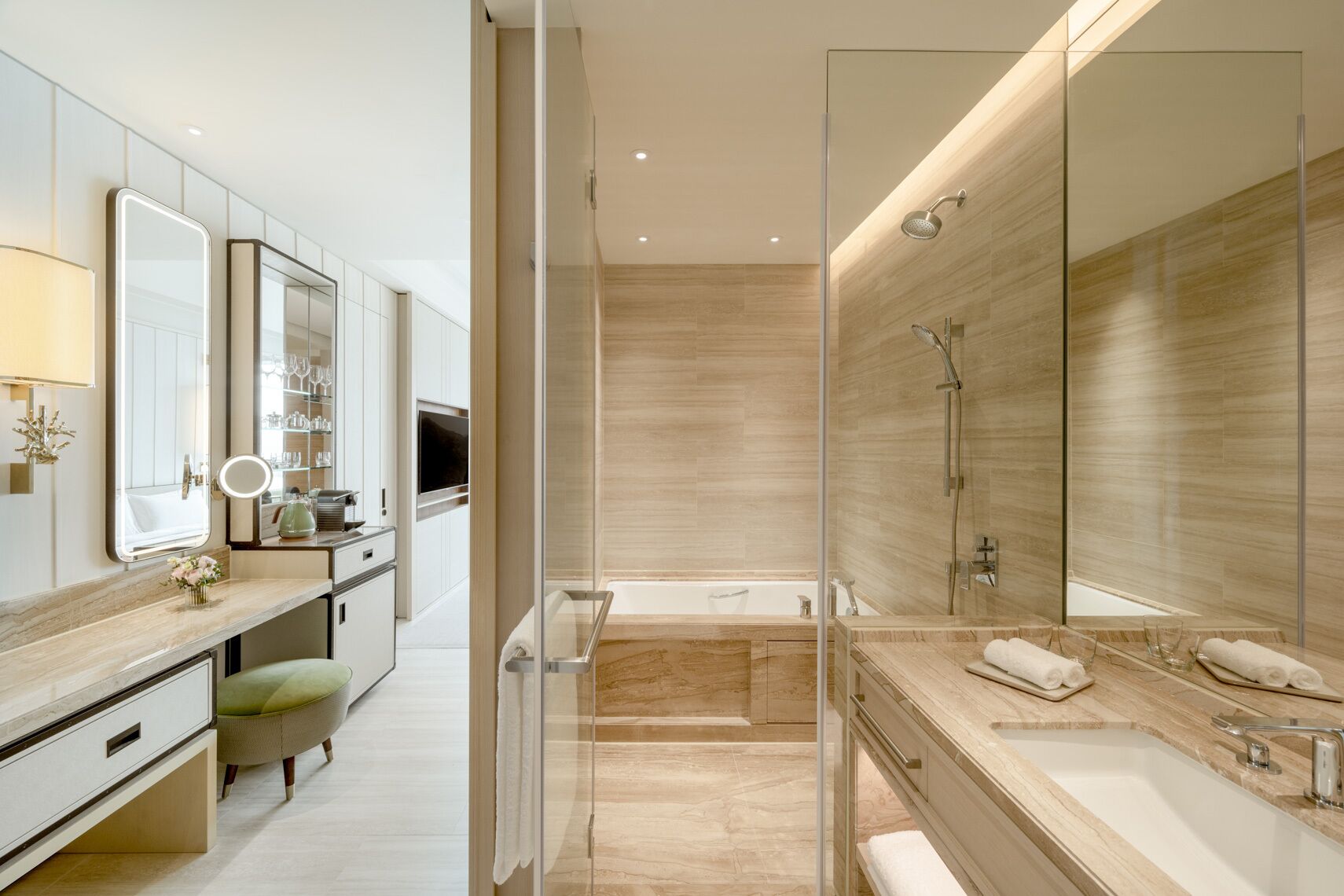 A modern bathroom with a glass-enclosed shower, a bathtub, and a vanity with a mirror.