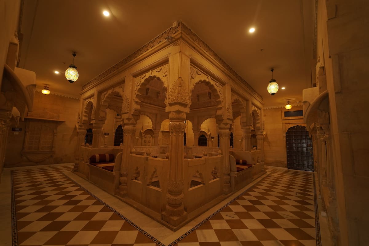 A checkered floor, ornate pillars, and a central structure with arches.