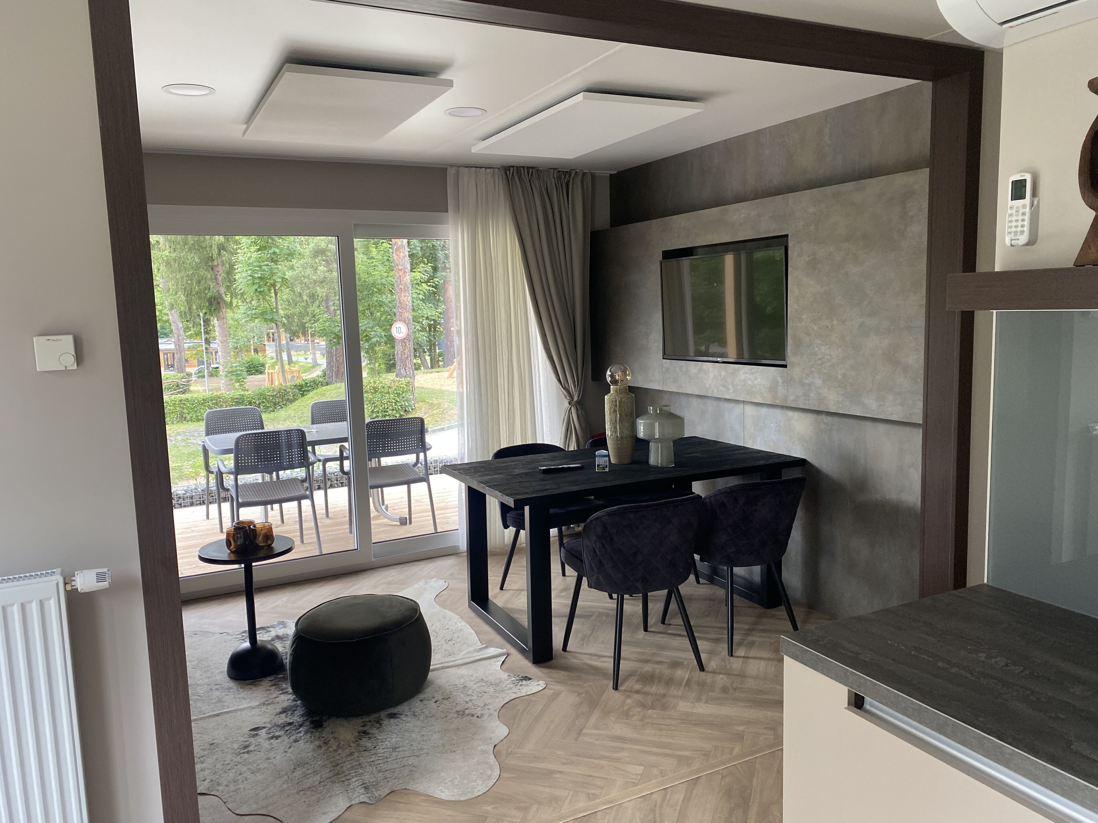 Una cocina moderna con comedor, ventanas amplias y vistas al exterior.