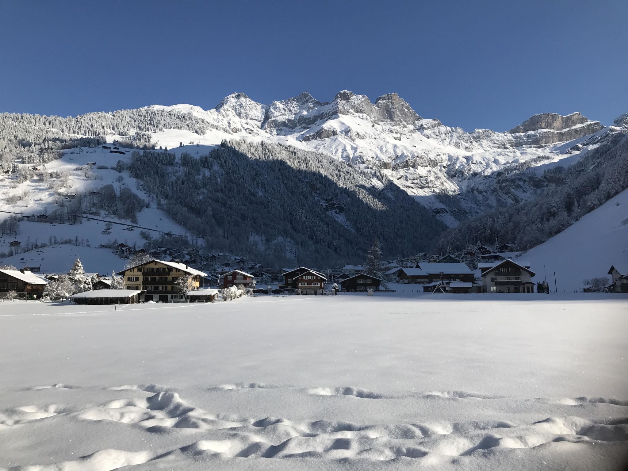 A snow-covered mountain landscape with a clear sky.
