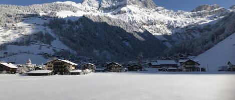 A snow-covered mountain landscape with a clear sky.
