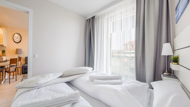 A hotel room with a bed, a desk, and a chair. - Apartamenty Sun & Snow Bursztynowa (Sztutowo)