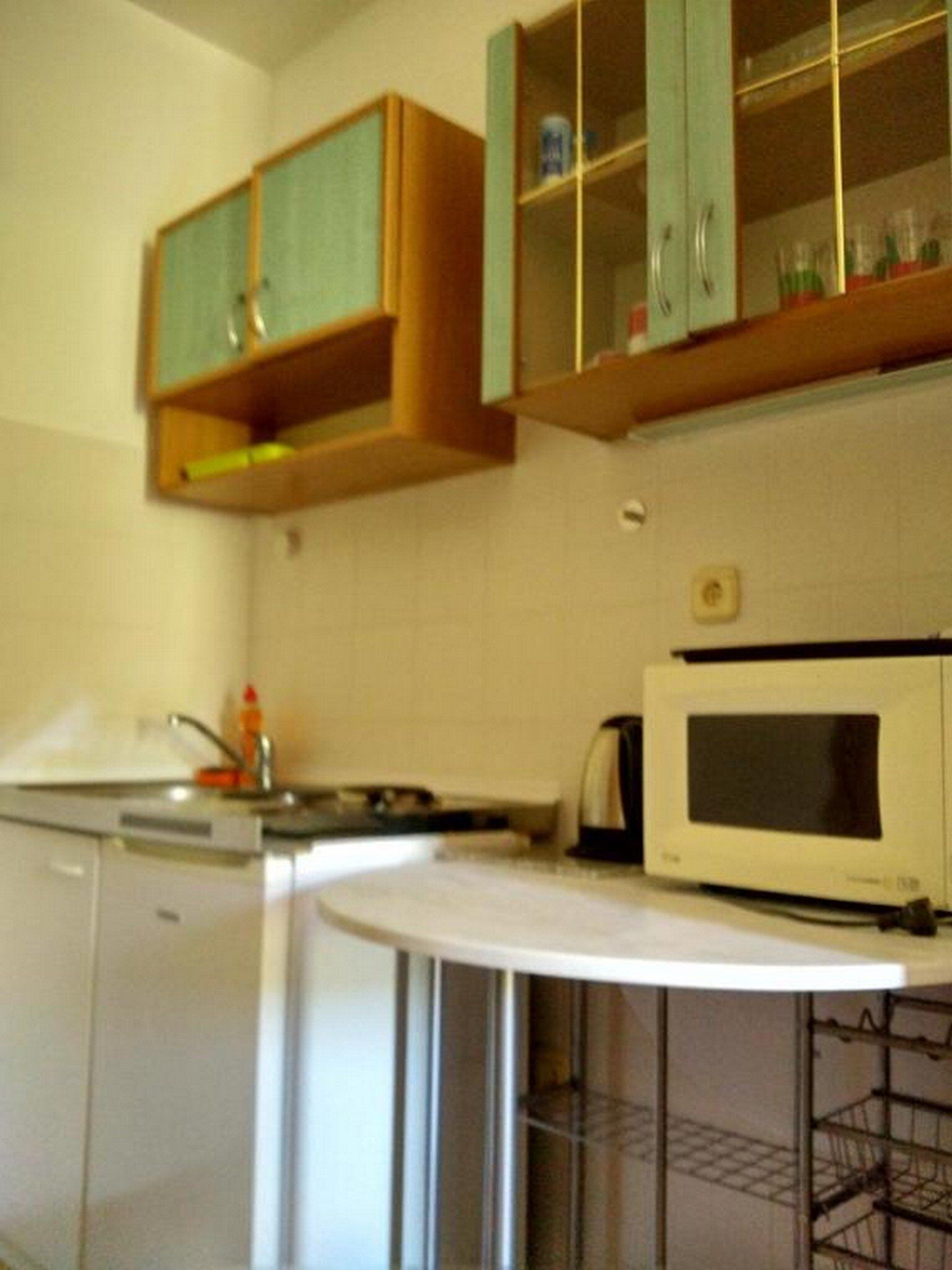 A kitchen with wooden cabinets, a microwave, and a dishwasher.