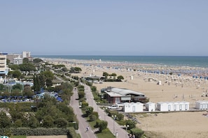 Guests can enjoy a beachside promenade with umbrellas and sun loungers.