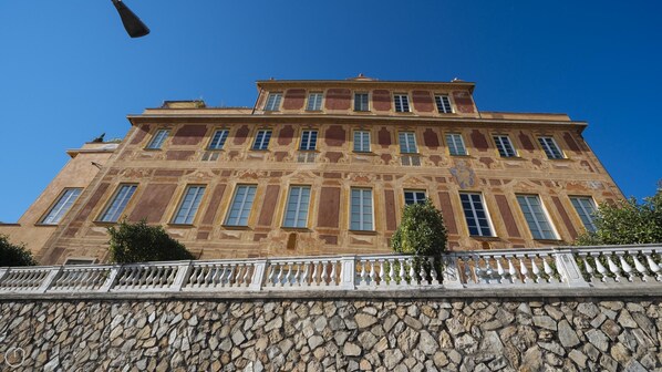 A large, ornate building with multiple windows and a stone facade.