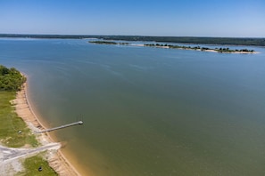 An aerial view of a river with a bridge and a sandy beach.