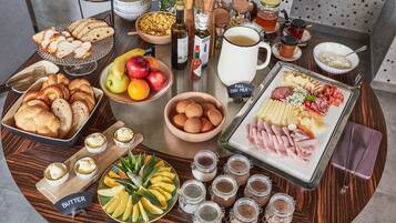 A breakfast buffet with various foods and condiments.