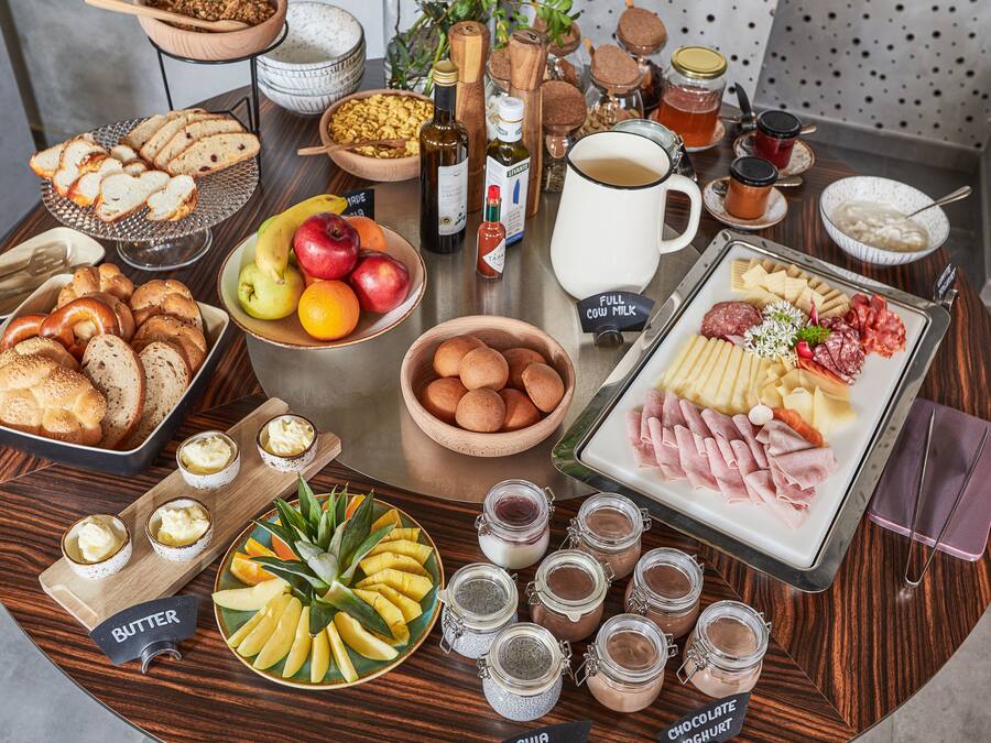 A breakfast buffet with various foods and condiments.