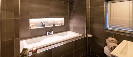 Bathtub, hair dryer, towels, soap