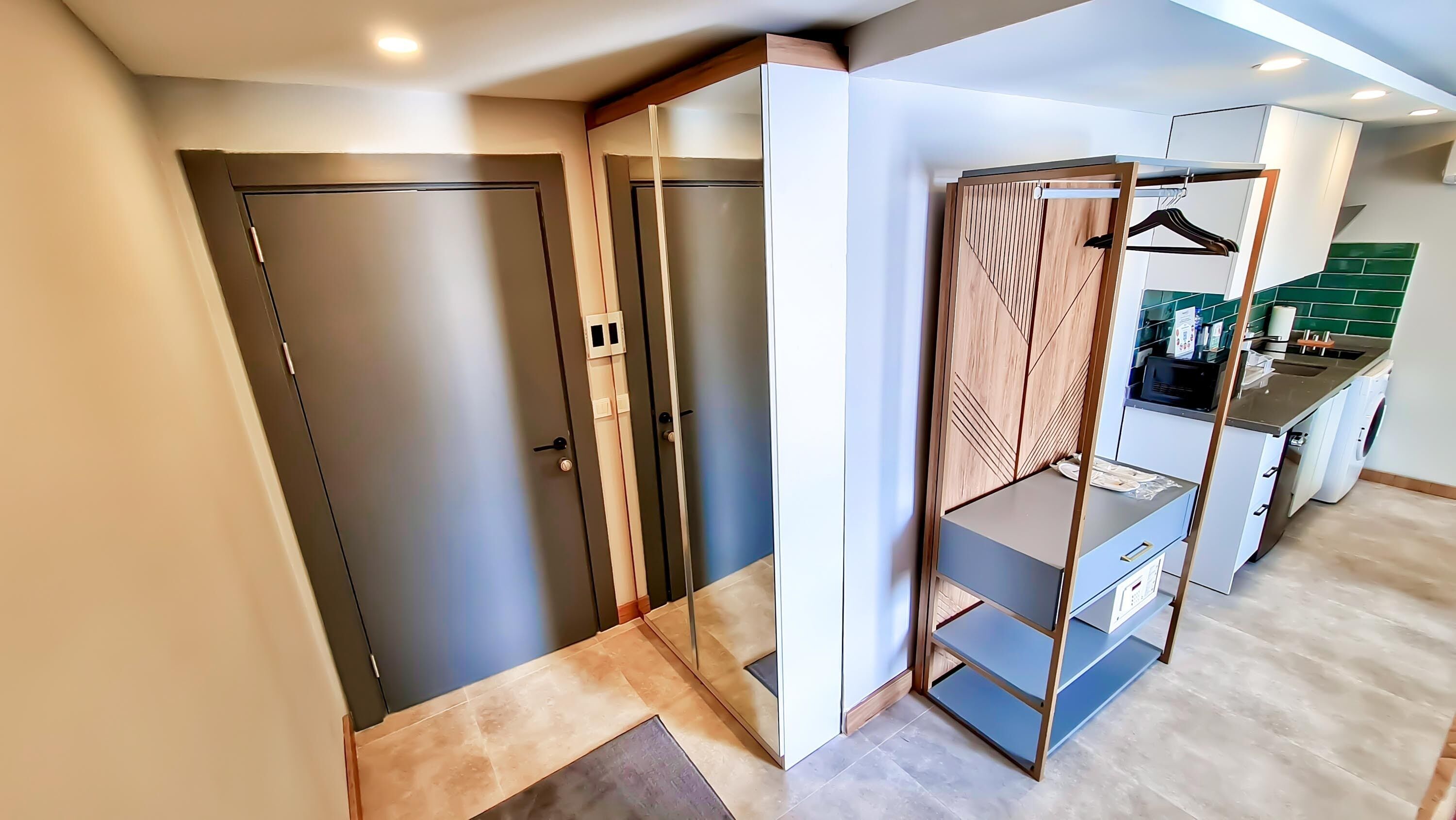 A modern kitchen with a built-in washing machine and a small dining area.