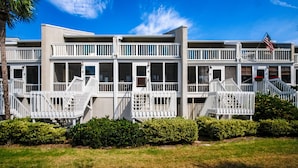 A two-story building with multiple balconies and a flag. - Beach Club Villa-Oceanviews in Wild Dunes- community pool & screened porch! (Isle of Palms)