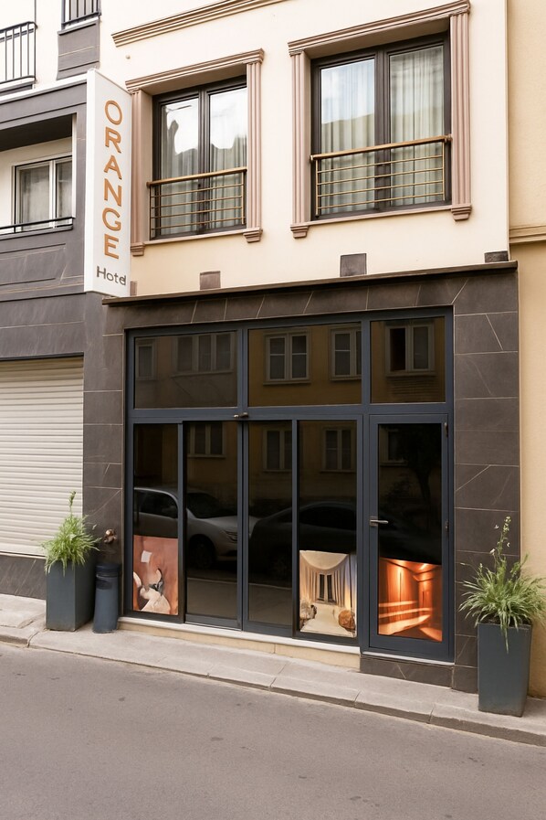 A hotel with a sign reading "Orange Hotel" and a large glass entrance. -  Orange Hotel & Spa (Istanbul)