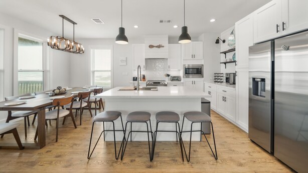A modern kitchen with a central island, stainless steel appliances, and pendant lighting. - New Build! Beach Front Luxury House w/Ocean Views & Breeze (Freeport)
