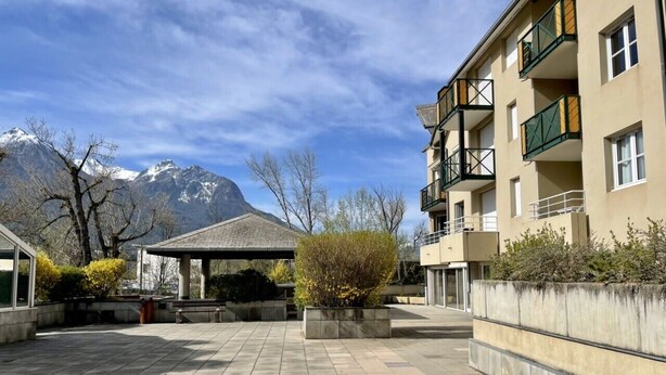 A courtyard with a gazebo, a building with balconies, and mountains in the background. - Bright 50 M² With Balcony And View On The Valley (Briançon)