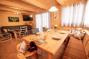 Cozy cabin interior with a dining area and seating space, perfect for relaxation and socializing.
