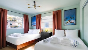 A hotel room with two beds, a view of palm trees, and a painting of a beach scene. - 131 · ☀Pool✔ Kitchen✔ Beach✔ Self Checkin✔ Free Parking✔ (Clearwater)