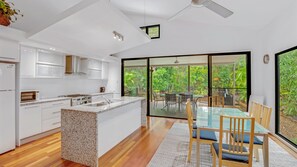 Enjoy meals in the kitchen with a granite countertop island, then dine al fresco overlooking the lush garden.