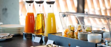 Un bufé de desayuno con diversas bebidas y alimentos.