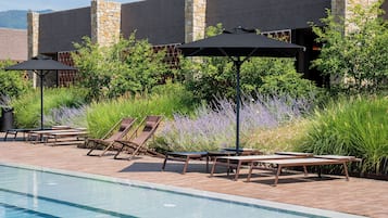 Seasonal outdoor pool, open 10:00 AM to 7:00 PM, pool umbrellas