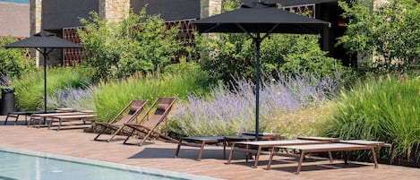 Seasonal outdoor pool, open 10:00 AM to 7:00 PM, pool umbrellas