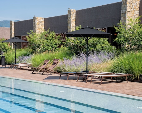 Seasonal outdoor pool, open 10:00 AM to 7:00 PM, pool umbrellas