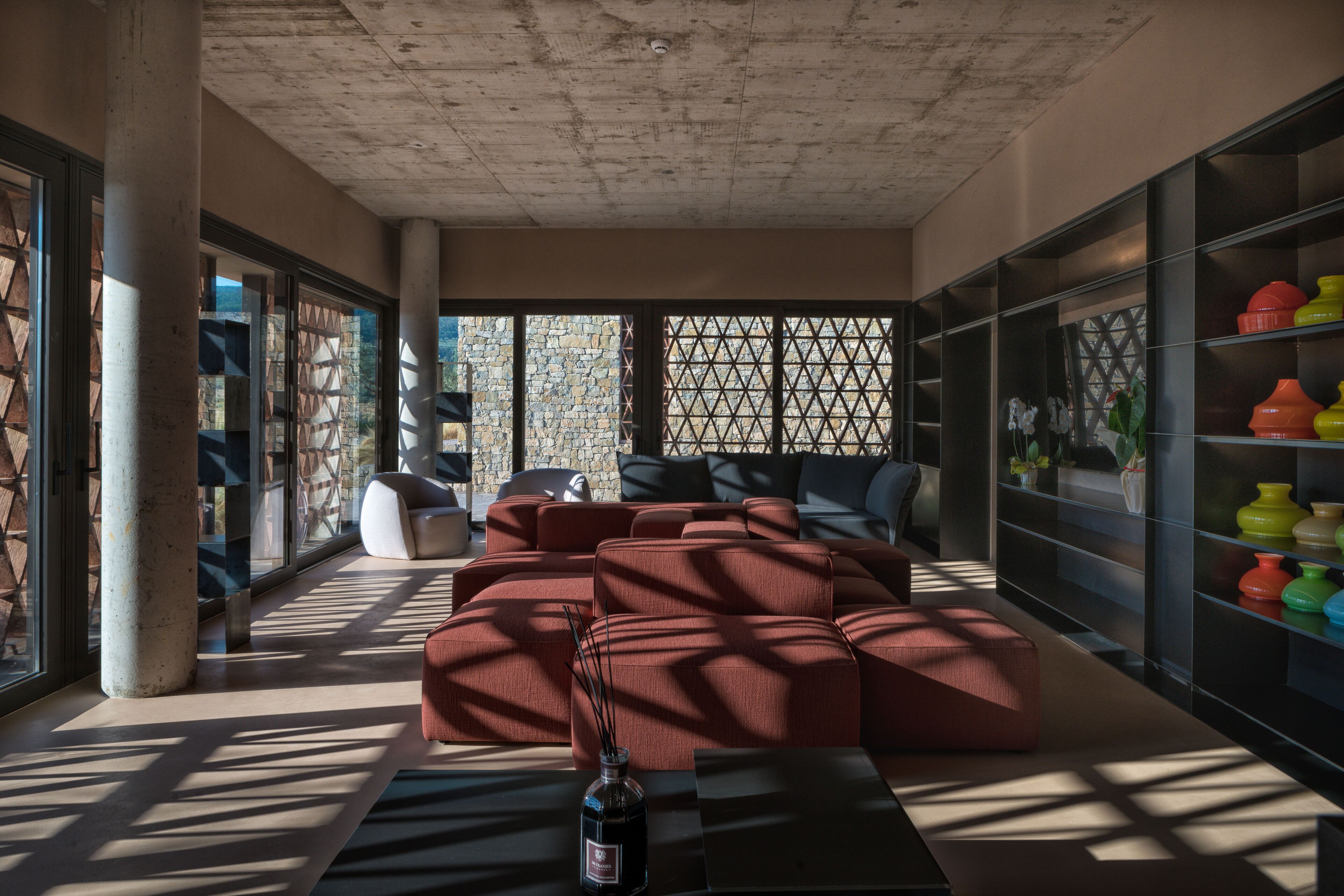 Una sala de estar moderna con un sofá modular, una mesa de centro y una estantería.